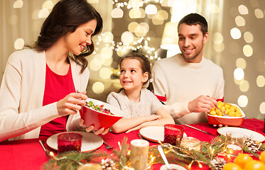 Image showing happy family having christmas dinner at home