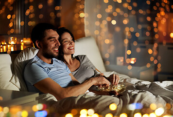 Image showing couple with popcorn watching tv at night at home