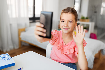 Image showing happy girl with smartphone taking selfie at home