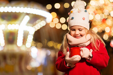 Image showing happy girl with cup of tea at christmas market