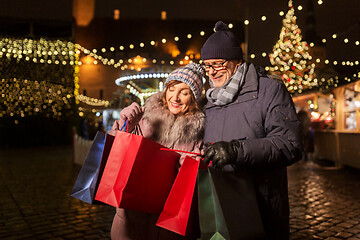 Image showing old couple at christmas market with shopping bags