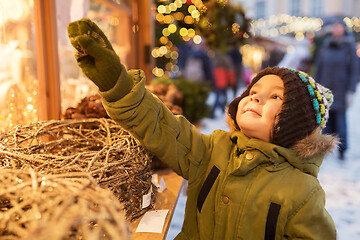 Image showing happy little boy at christmas market in winter