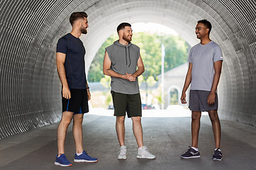 Image showing young sporty men or male friends talking outdoors