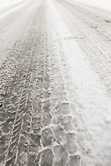 Image showing car tire imprint on the snow melted