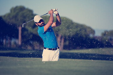 Image showing pro golfer hitting a sand bunker shot