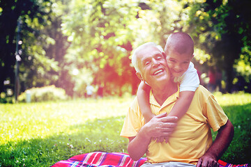 Image showing grandfather and child have fun  in park