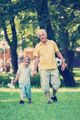 Image showing grandfather and child have fun  in park