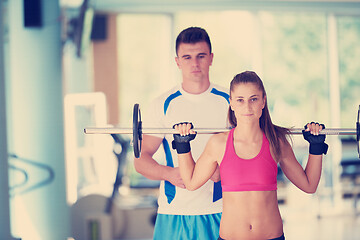 Image showing young sporty woman with trainer exercise weights lifting