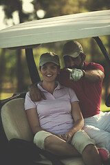 Image showing couple in buggy on golf course