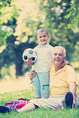 Image showing grandfather and child have fun  in park