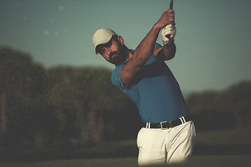 Image showing pro golfer hitting a sand bunker shot