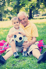 Image showing grandfather and child have fun  in park