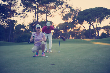 Image showing couple on golf course at sunset