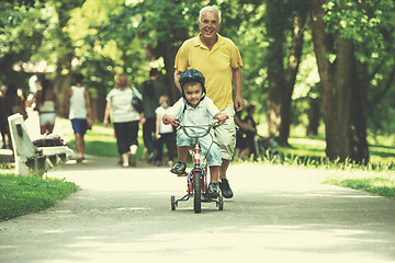 Image showing grandfather and child have fun  in park