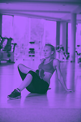 Image showing woman stretching and warming up for her training at a gym