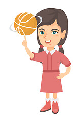 Image showing Caucasian girl spinning basketball ball on finger.