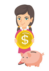 Image showing Caucasian girl putting a coin into a piggy bank.