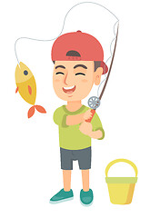 Image showing Little boy holding fishing rod with fish on hook.