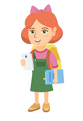 Image showing Little schoolgirl holding cellphone and textbook.