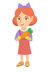 Image showing Caucasian girl holding fresh carrot.