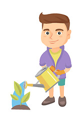 Image showing Caucasian boy watering plant with a watering can.