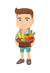 Image showing Boy holding basket with fruit and vegetables.