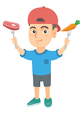 Image showing Caucasian boy holding fresh carrot and steak.