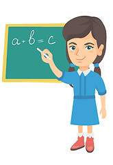 Image showing Caucasian schoolgirl writing on the blackboard.