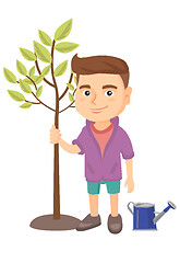 Image showing Caucasian smiling boy planting a tree.