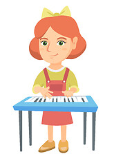 Image showing Little caucasian girl playing the piano.