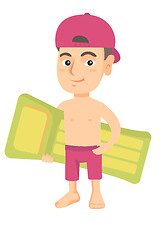 Image showing Little caucasian boy holding inflatable mattress.