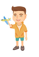 Image showing Caucasian cheerful boy playing with a toy airplane