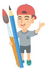 Image showing Smiling boy holding big pencil and paintbrush.