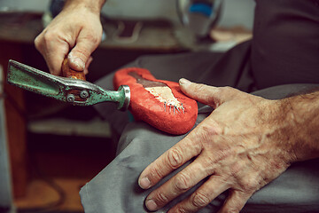 Image showing Enjoying process of creation custom made shoes. Workplace of shoe designer