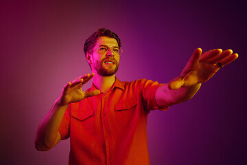 Image showing The happy business man standing and smiling against pink background.