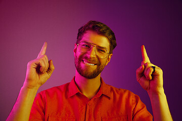 Image showing The happy business man standing and smiling against pink background.