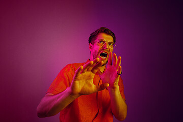 Image showing Portrait of the scared man on pink