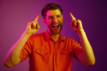 Image showing The happy business man standing and smiling against pink background.