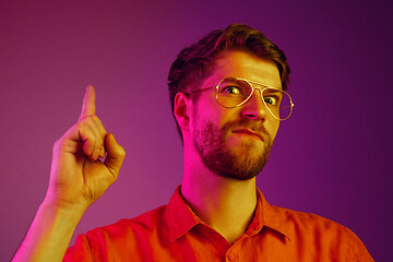 Image showing The happy business man standing and smiling against pink background.