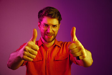 Image showing The happy business man standing and smiling against pink background.