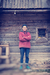 Image showing young hipster in front of wooden house