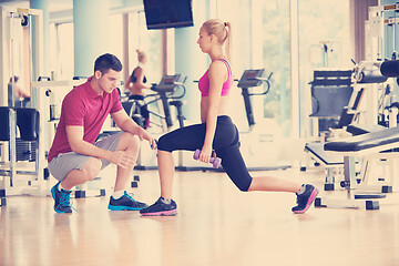 Image showing young sporty woman with trainer exercise weights lifting