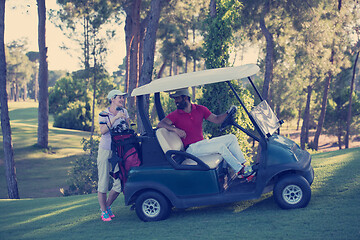 Image showing couple in buggy on golf course