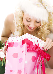 Image showing lovely santa helper girl with christmas gifts