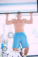 Image showing handsome young mand working out in gym