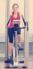 Image showing womanworkout  in fitness club on running track machine 