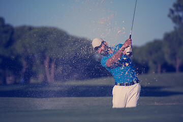 Image showing pro golfer hitting a sand bunker shot