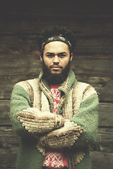 Image showing portrait of young hipster in front of wooden house