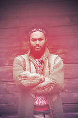 Image showing portrait of young hipster in front of wooden house