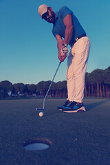 Image showing golfer  hitting shot at golf course